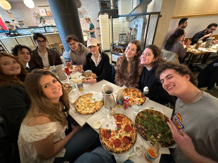 Clockwise from Kadin: Pam, Tom, Zack, Max, Christina, Lisanne, Ioli, and Mo at a pizza place