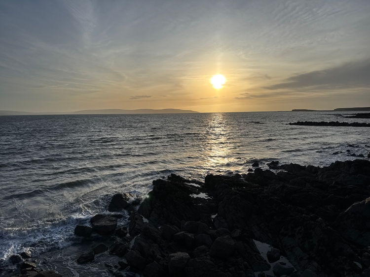 The beach at sunset with a beautiful orange sky