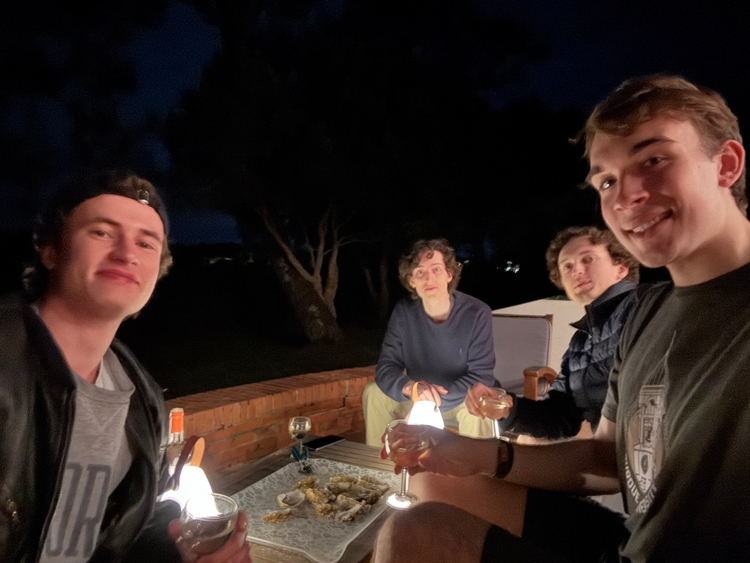 Mo, Tom, Ryan, and I on the deck at night eating some oysters